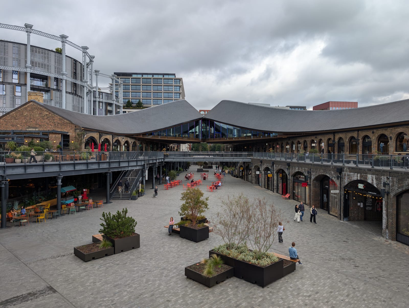 Coal Drops Yard at King's Cross, with Heatherwick's kissing roof over the brick viaducts.