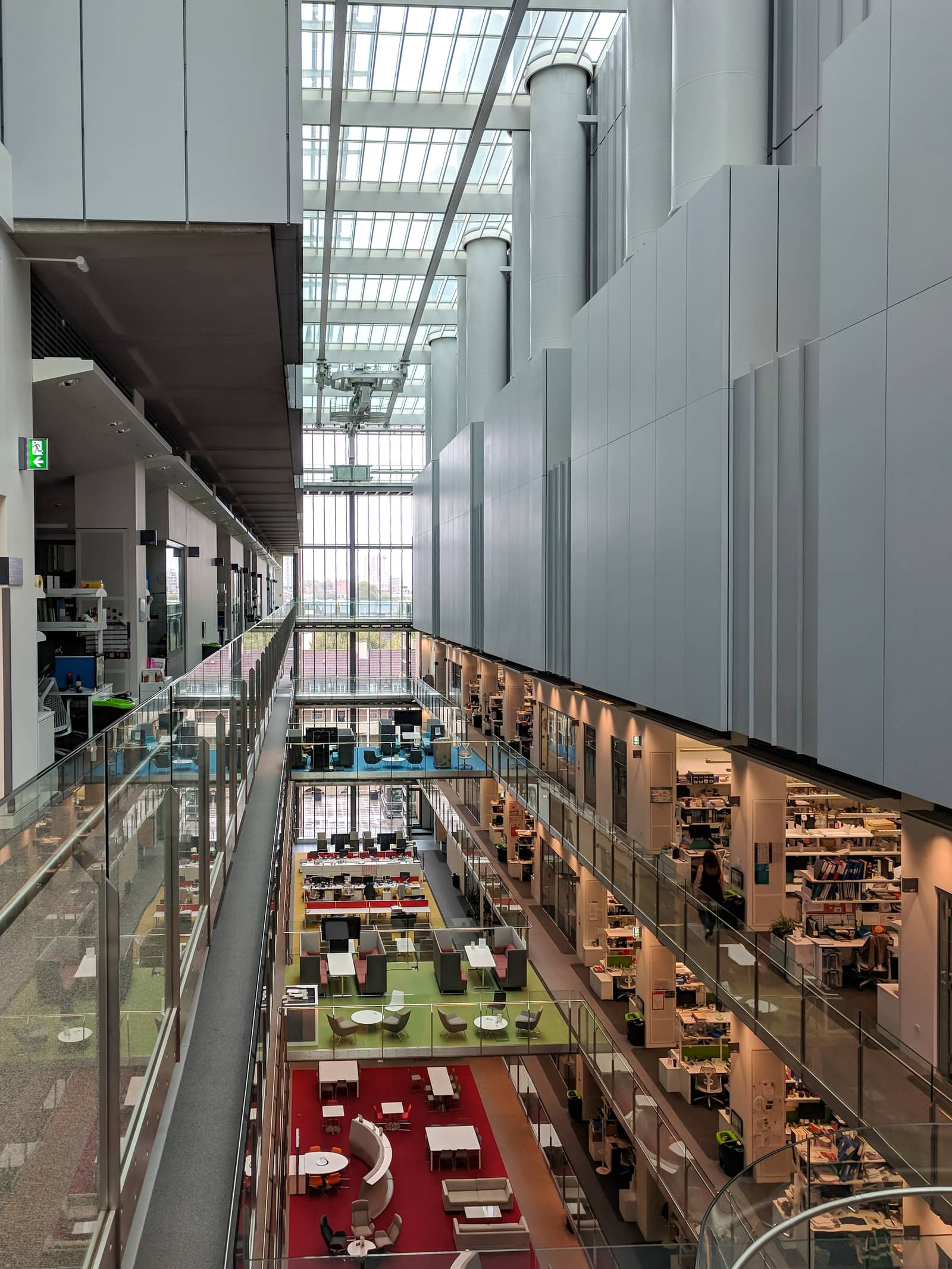 The atrium inside the Francis Crick Institute, with labs behind glass.