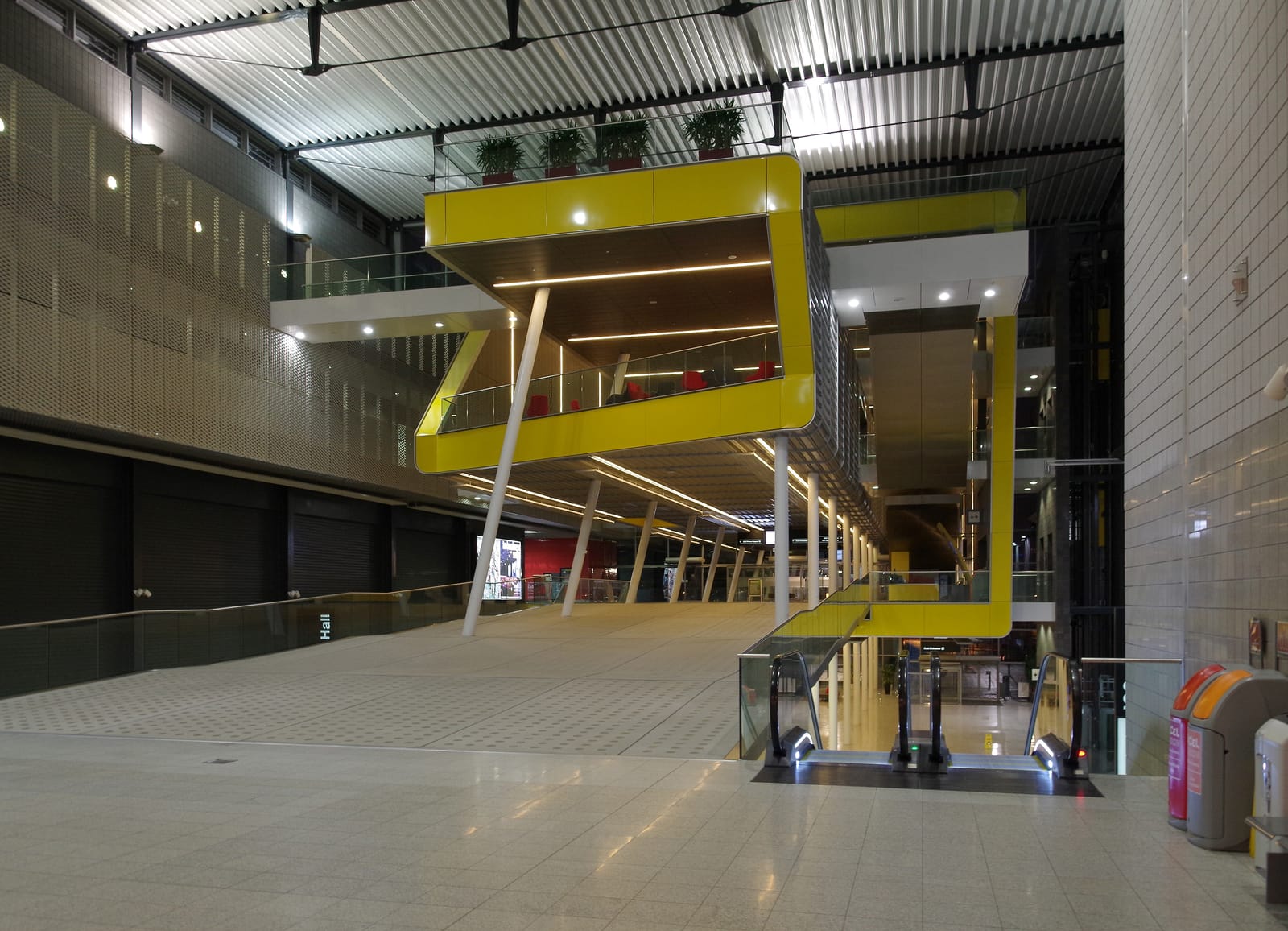 The main concourse inside ExCeL London, with its yellow suspended meeting pods.