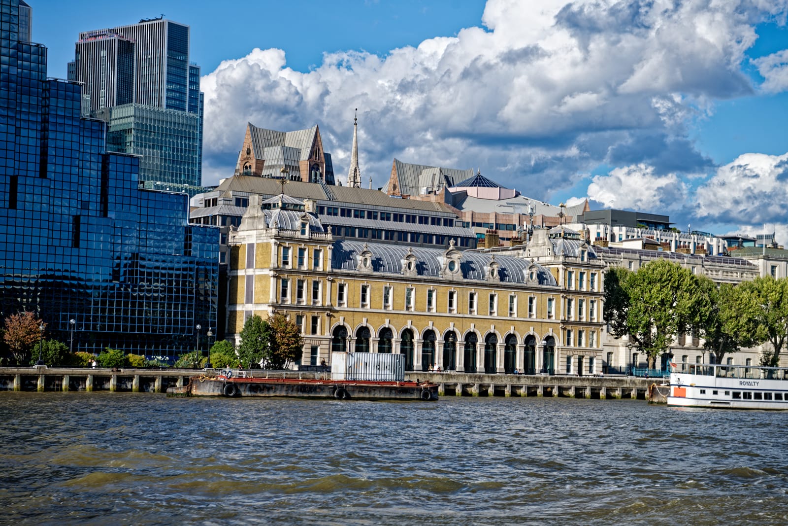 Old Billingsgate Market seen from the Thames, its arcaded river frontage below the City towers.