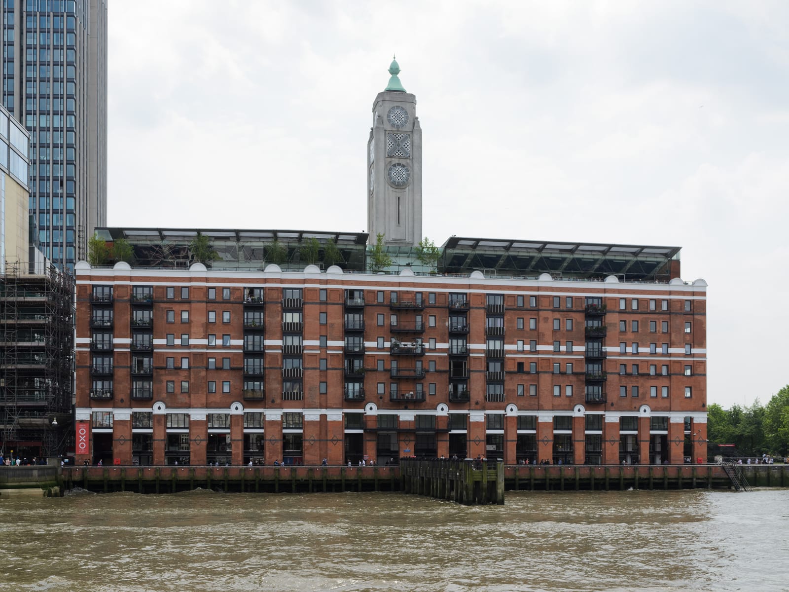 Oxo Tower Wharf from the Thames, with the landmark tower rising behind the riverfront building.